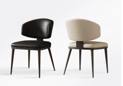 Liam modern curved dining chair in black and beige upholstery with carbon steel legs.