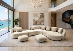 Ondina modern curved modular fabric sofa in light beige, featuring an organic flowing silhouette in a minimalist living room.