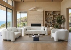 Bora modern chunky fabric lounge suite in cream boucle upholstery, featuring oversized rounded arms in a serene coastal living room.